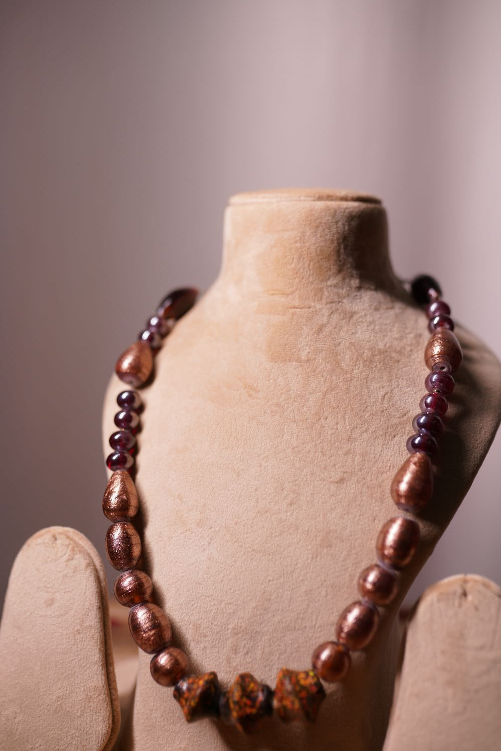Bronze beads with ornate decorative centerpiece