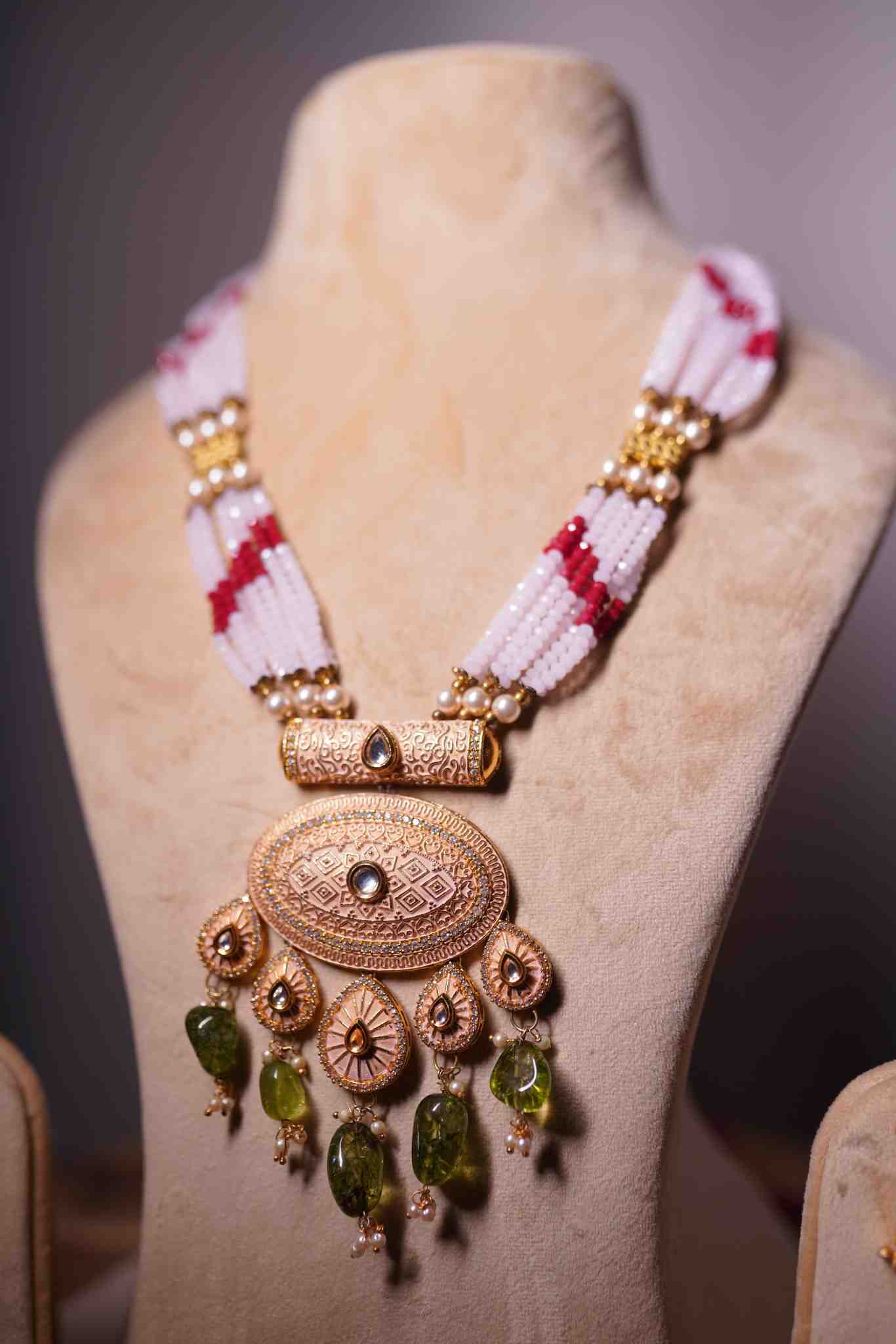 Green jade drops and beaded strap on antique gold mala