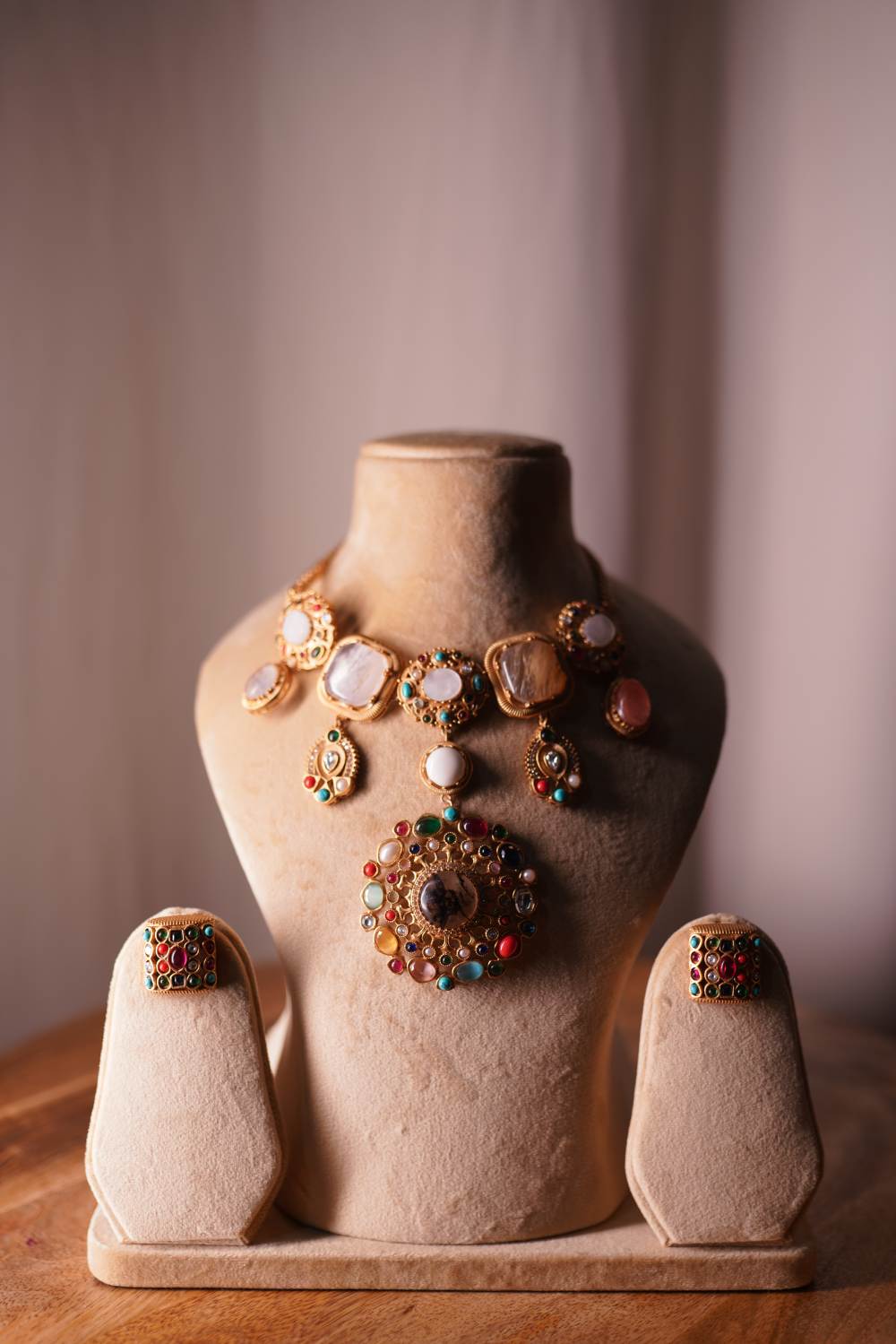 Woman wearing Navratan cascade bridal necklace with traditional lehenga