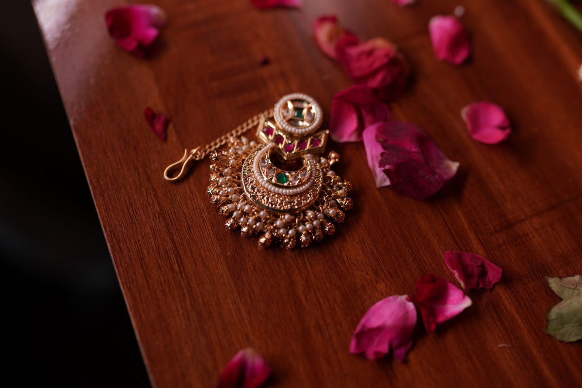 Antique gold maang tikka with green stone detailing