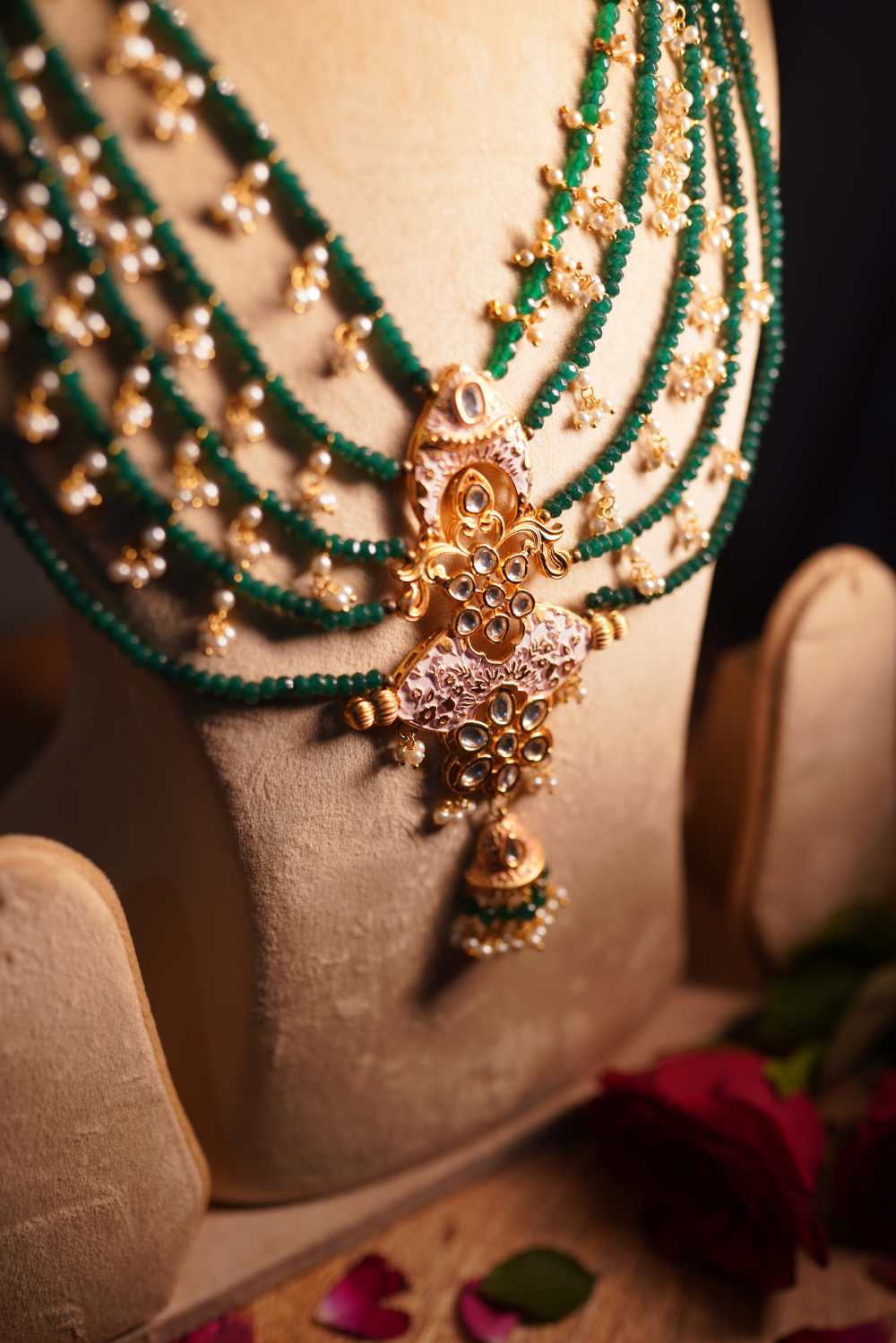 Antique gold plated temple pendant on emerald green mala