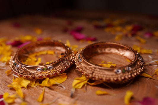 Golden bangles with intricate filigree and granulation work