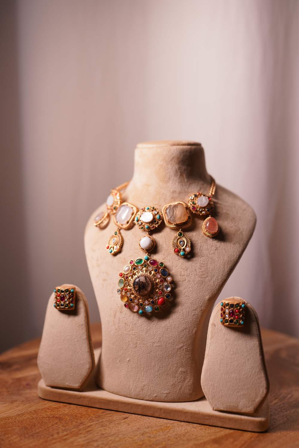 Detailed view of handcrafted Navratan gemstones and intricate meenakari work on the Fashiyano cascade bridal necklace.