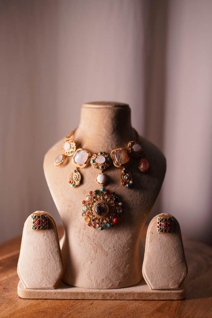 A royal bridal ensemble featuring the Fashiyano Navratan Cascade Necklace styled with a traditional red wedding lehenga