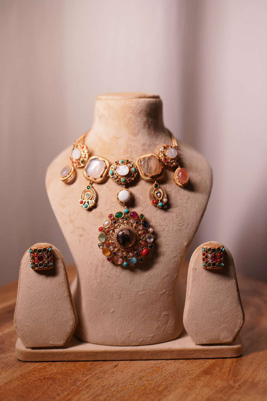 Fashiyano Navratan Cascade Bridal Necklace: A grand multi-layered wedding necklace featuring traditional nine precious gemstones set in gold-plated kundan