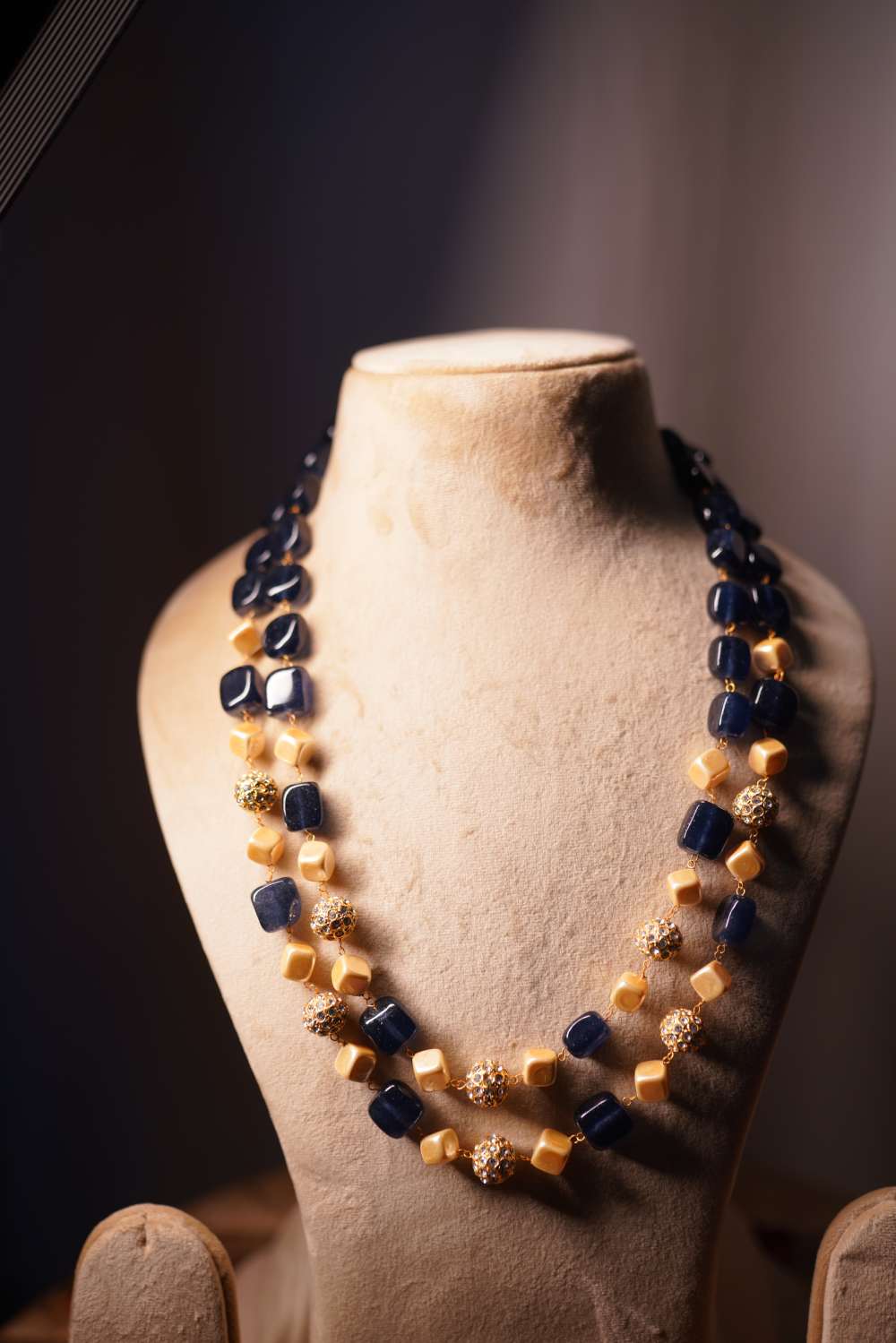 Navy blue gemstone beads with textured golden beads