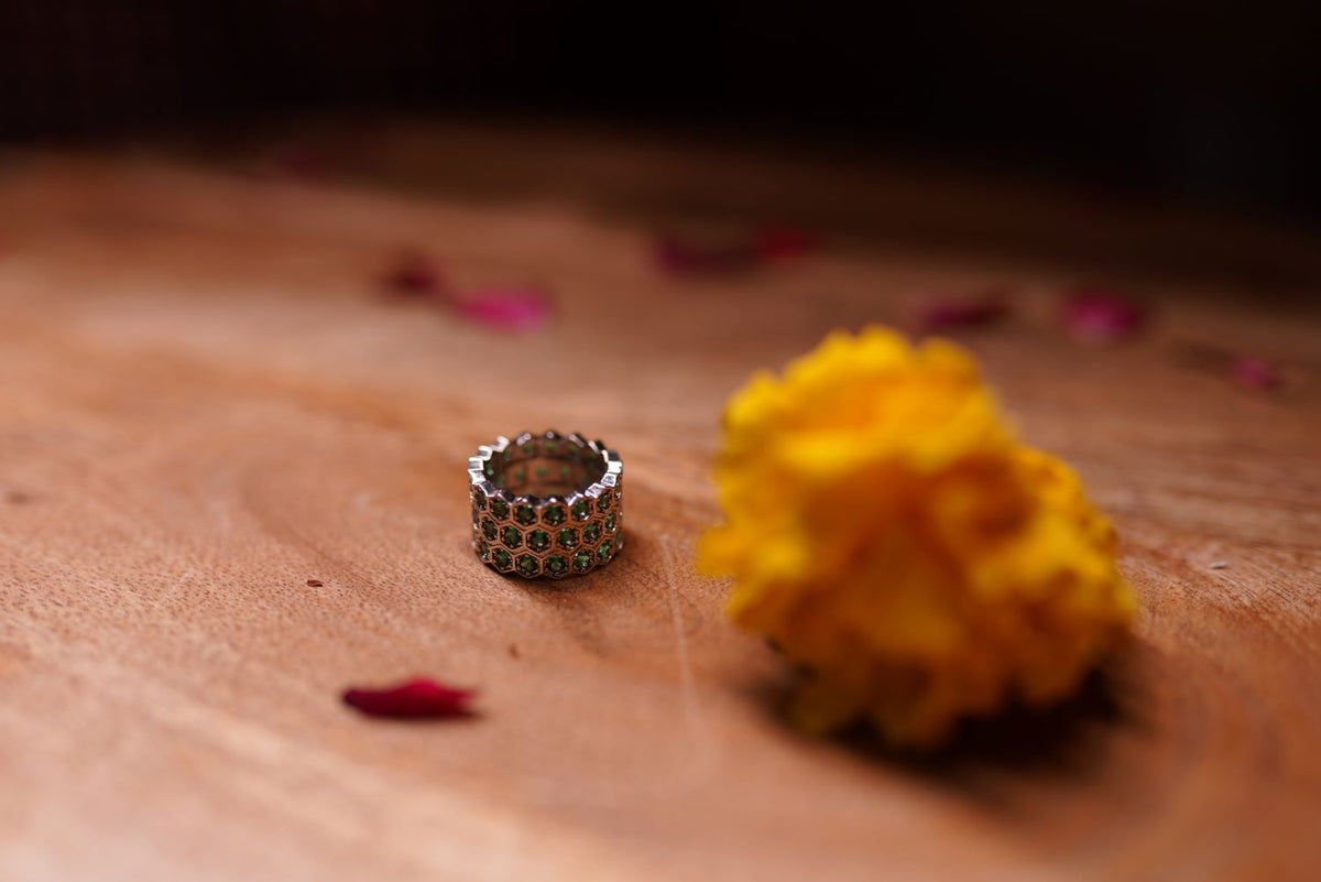 Silver-tone ring with green stone accents