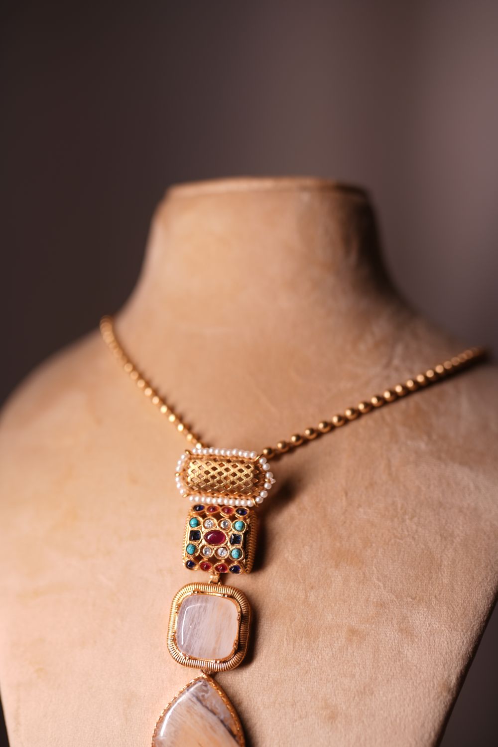 Vertical cascade necklace with pearl ruby emerald and turquoise accents