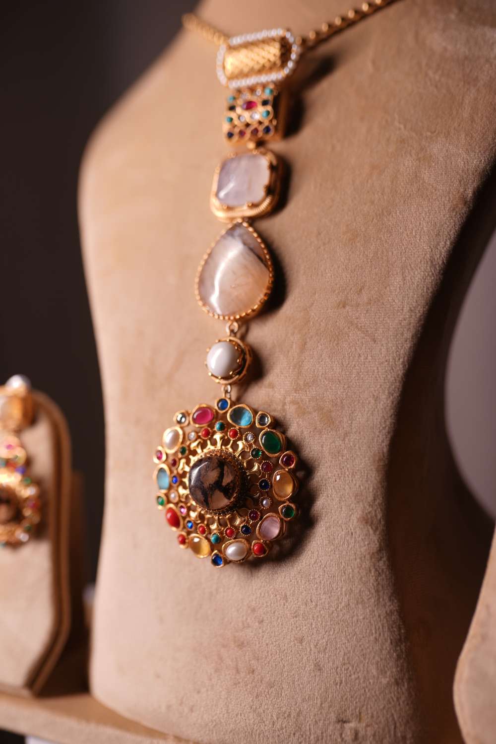 Vertical cascade necklace with pearl ruby emerald and turquoise accents